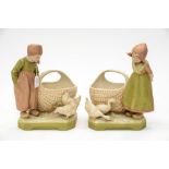 A pair of Royal Dux Dutch girl and boy figural baskets,
