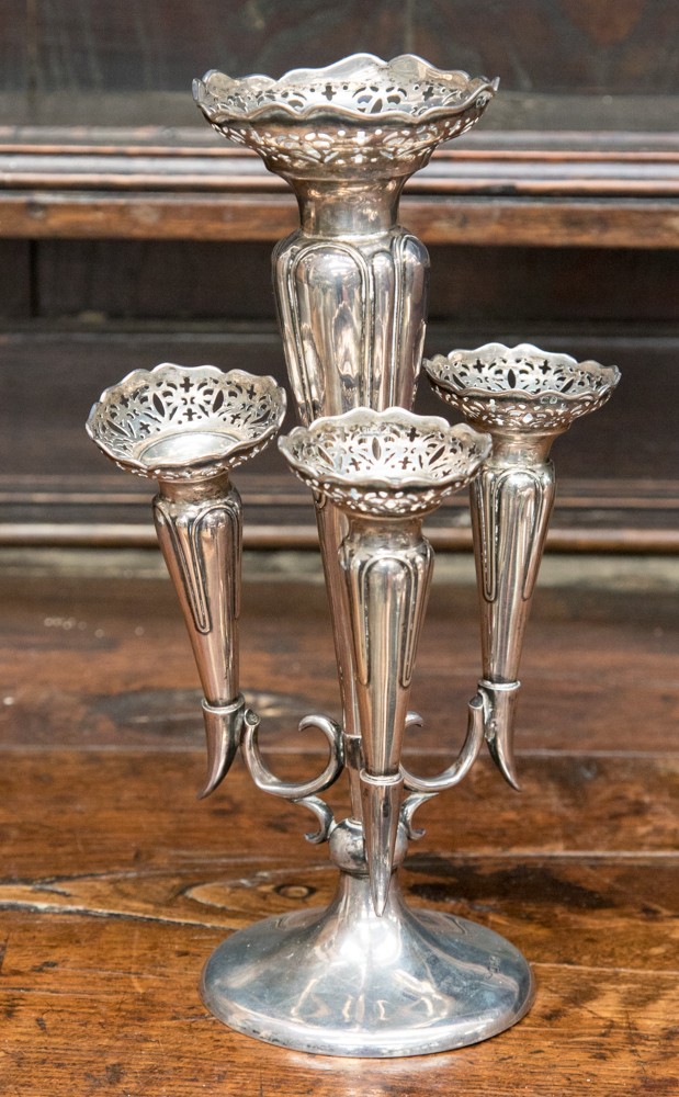 A George V silver epergne with central posy vase with pierced flared rim and three further trumpet