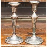 A pair of classical style silver candlesticks,