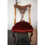 A set of four late Victorian walnut dining chairs,
