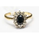 A sapphire and diamond 18ct yellow gold cluster ring, ring size 0. gross weight approximately 4.