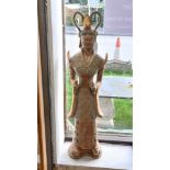 A painted terracotta figure of woman in traditional dress, having two handled head dress,