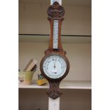 A 19th Century oak cased barometer and thermometer