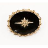 A Victorian black onyx and seed pearl yellow gold (unmarked) mourning oval brooch,