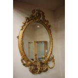 A 19th Century or later gilt framed oval mirror