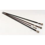Two ebonised silver topped walking canes; together with two others with silver knop handles,