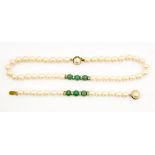 A faux pearl necklace with hard greenstone beads and diamante decoration,