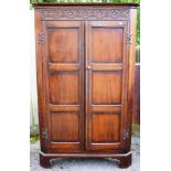 A 19th Century oak free standing corner cupboard, the cornice carved with rosettes and roundels,