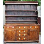 A George III oak dresser and rack, circa 1800, the rack with three plate shelves,