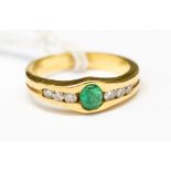 An emerald, diamond and 18ct gold dress ring,