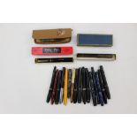 A large collection of vintage fountain pens including Parker, Swan, Platignum,