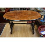 A Victorian walnut quarter veneered occasional table, each side raised on turned columns,