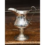 A George III silver cream jug, plain baluster shape on pedestal circular foot, S-scroll handle,
