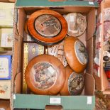 A collection of seven cribbage boards with five flatware pot lids in wooden frames,