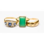 An early 20th century, 18ct gold ring set with a large emerald green stone, ring size J,