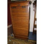 An early 20th Century oak tambour fronted cabinet