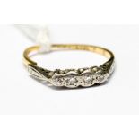 An 18ct gold and platinum ring set with four small diamonds a/f