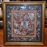 A Chinese embroidered framed and glazed, possibly, cushion cover,