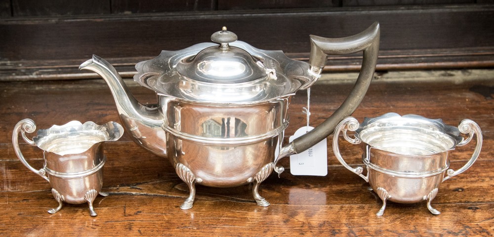 A three piece silver tea set comprising teapot with ebony handle and finial,