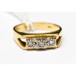 An 18ct gold ring set with three diamond chips weighing approx 5.