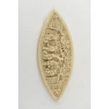 A Chinese carved ivory thread lozenge, relief figures in gardens,