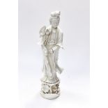 A Blanc de Chine figure of Chinese woman, with lotus flowers.