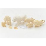 A collection of 19th and 20th century African carved ivory animals, including lions, leopard,