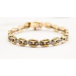 A 9ct yellow and white gold flat link diamond bracelet (approx total diamond weight 0.