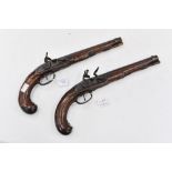 A pair of 18th Century Kuchenreuter flintlock dueling pistols, walnut stocks, metal butts,