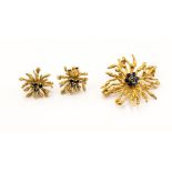 A yellow metal organic design brooch and earring suite set with sapphires,