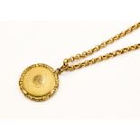A 9ct gold chain with a yellow metal surround pendant with platted hair