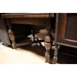 An early 20th Century oak draw-leaf table,