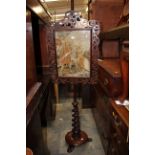 A Victorian pole screen, the fretwork applied screen having a woolwork panel,