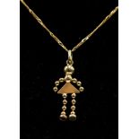 18ct gold pendant and chain in the form of a girl on a figaro,