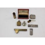 A collection of curios to include two Half Sovereign holders, comb, razor, propelling pencil,