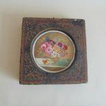 An English porcelain floral decorated plaque set into a heavy plaster frame, circa 1820,