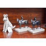 Two marble mounted spelter figures of jockeys on horseback,