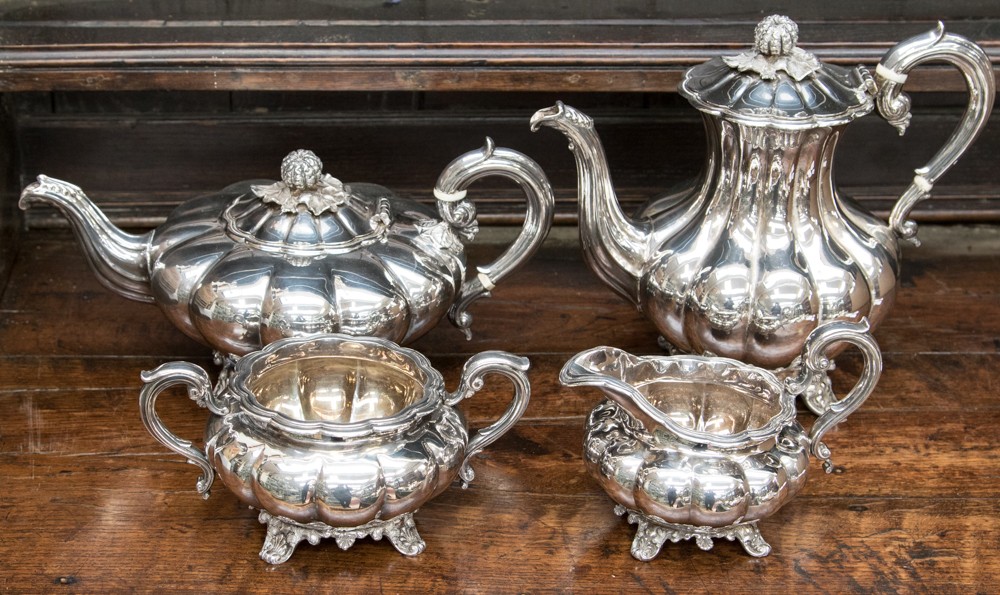 An Elizabeth II four piece silver tea and coffee service, melon-shaped comprising coffee pot,