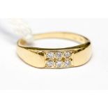 An 18ct gold ring pave set with six small diamonds, approx 0.