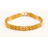 An Asian design 22ct yellow gold bracelet, fancy gate and wheel pattern links, 16.