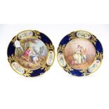 A pair of 19th century Serves cabinet plates, painted with Watteau style scenes of courting couples,