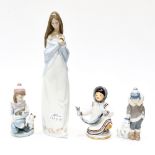 A Lladro figure , 'Fridays Child', and another Lladro figure of a boy and polar bear cub,