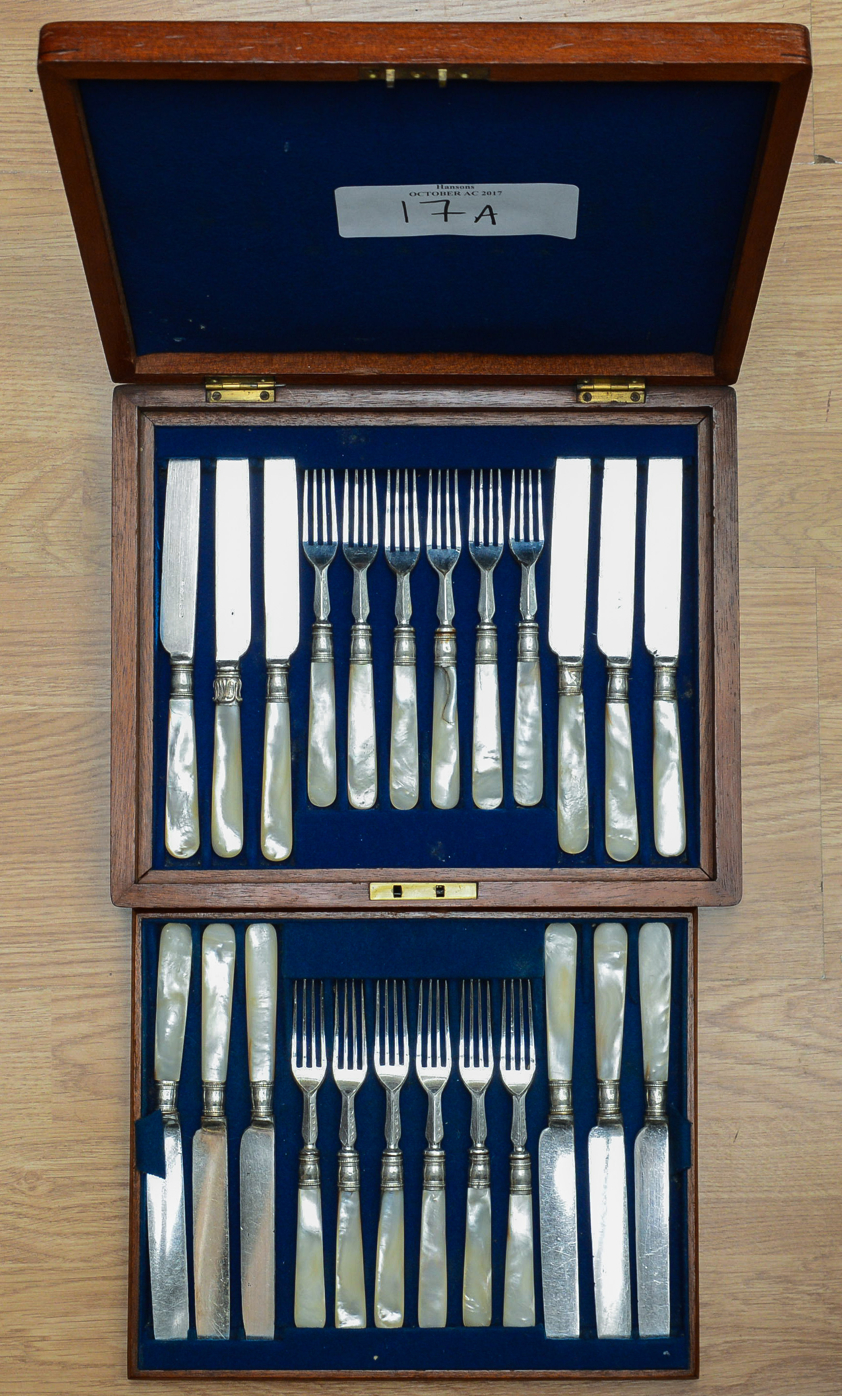 A matched set of twelve early 20th Century silver-plate fruit knives and forks,