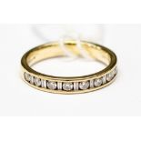 A diamond and 9ct gold half eternity ring,