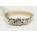 An 18ct yellow gold and diamond three stone ring, central diamond weighing approx .