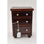 A small chest of drawers,