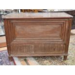 An 18th Century oak coffer, with a decoratively panelled and carved front,