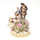 A large Meissen figure group with people dancing and playing instruments,