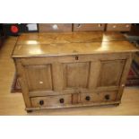 An 18th century oak mule chest, the front with raised and fielded panels,