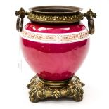 A late 19th Century red ground ovoid form and brass based jardiniere and stand,